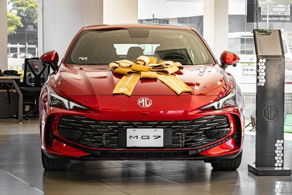 Red mg 7 car decorated with a large gold bow